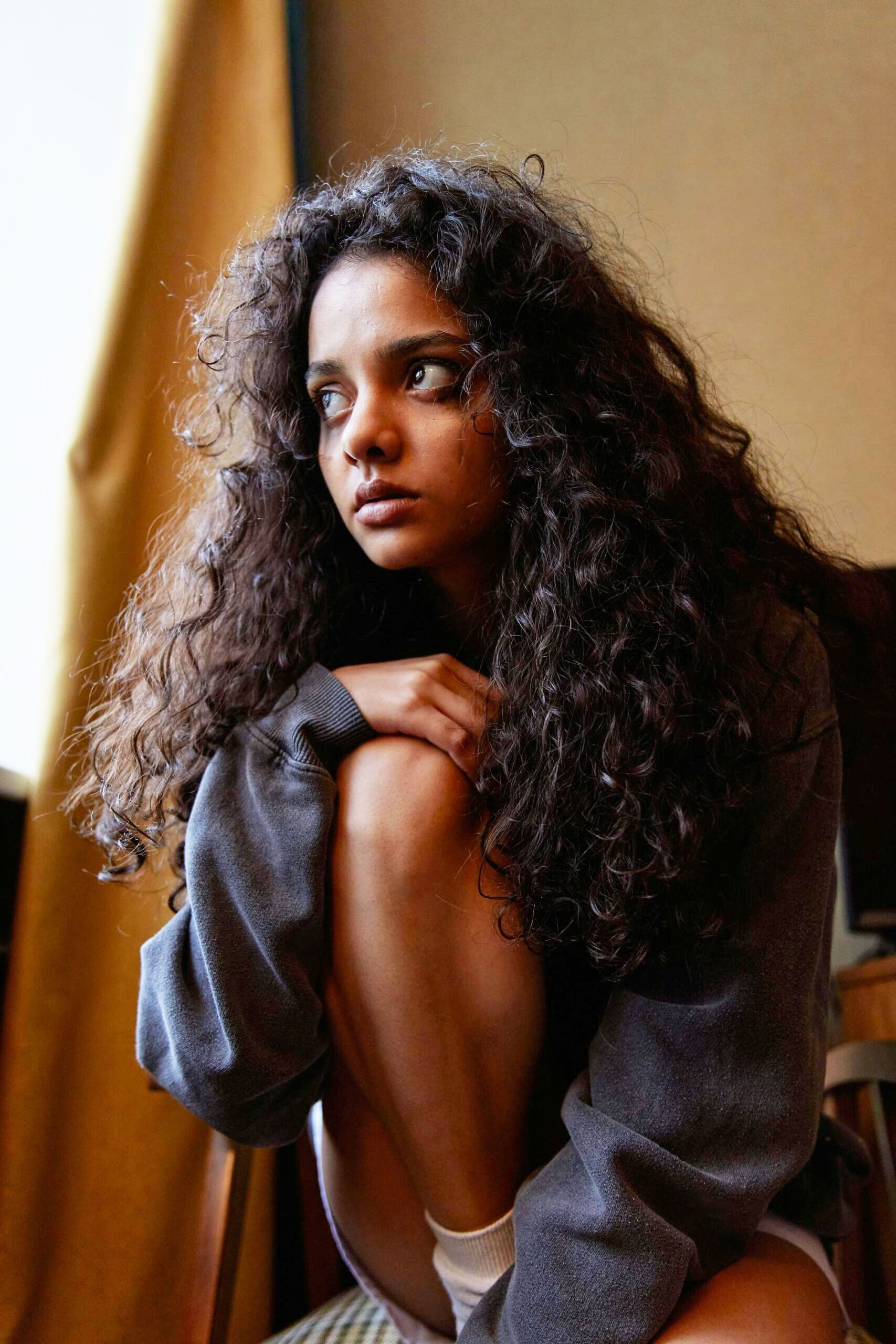 Woman Sitting On A Chair Looking Far In The Distance